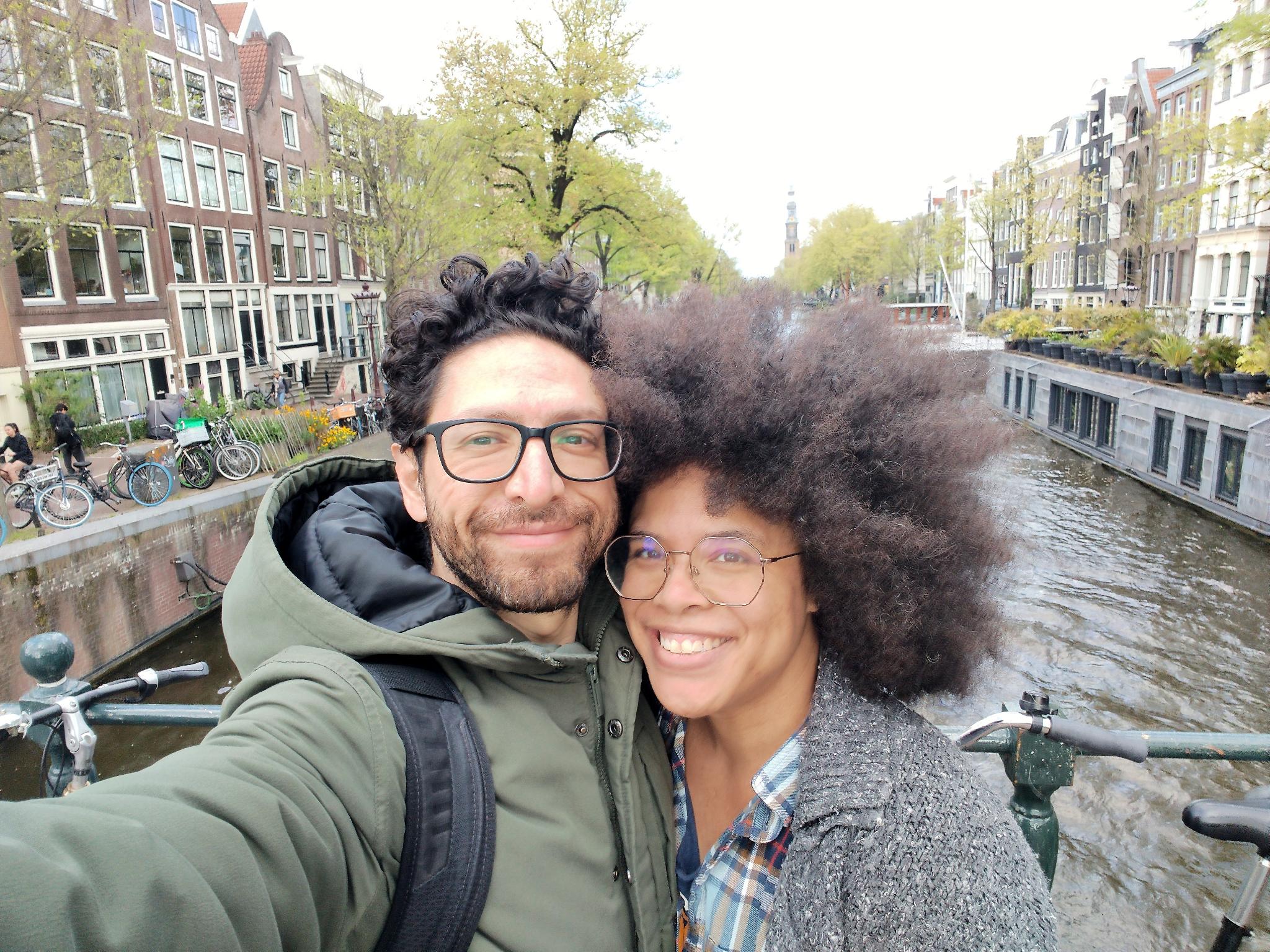 Allan and misha take a selfie on a bridge overlooking a canal. 